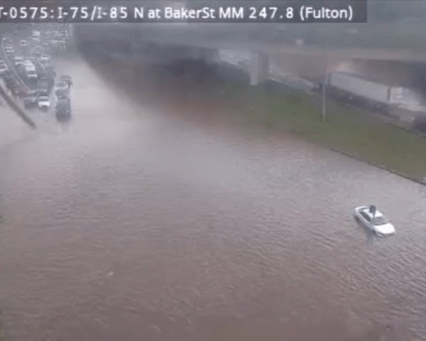 An image captured from video recorded by the Georgia Department of Transportation's 511 traffic camera shows a vehicle on the Downtown Connector surrounded by water from a flash flood on May 20. (Georgia Department of Transportation)