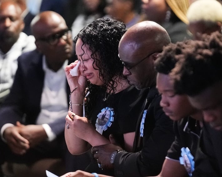 Christine Wonsley cries next to her husband, Elmore, and their sons Elmore Jr. and Ethan during a memorial service Monday for her son Nolan Xavier Wells. (Gerald Herbert/Associated Press)